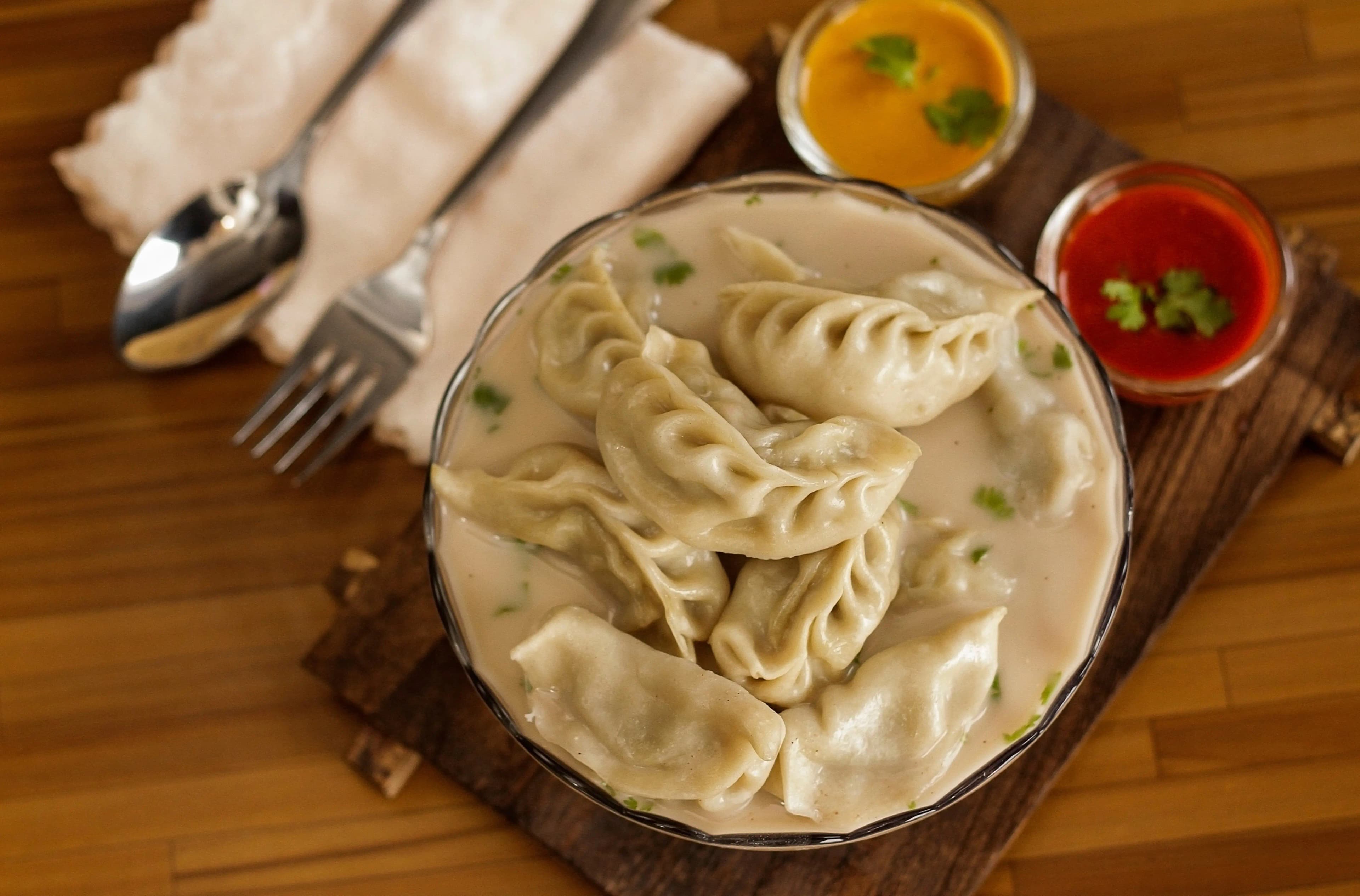 Steamed momo in a spiced jhol soup